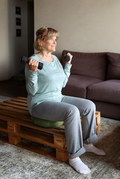 Old woman doing fitness exercises