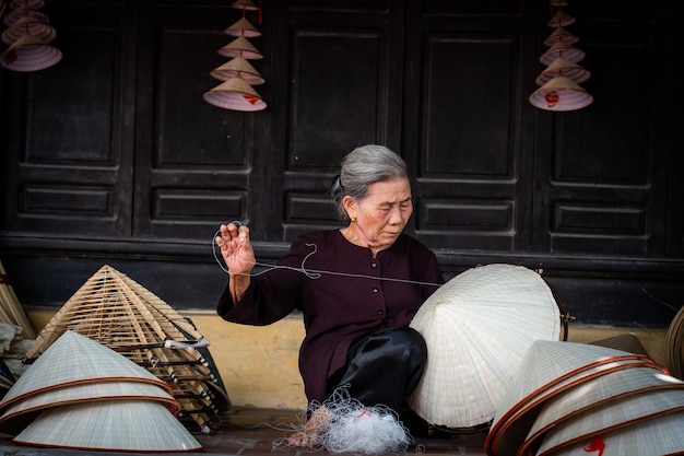 old woman making conical hats Vietnamese name is Non la Lang Chuong village Hanoi city Vietnam