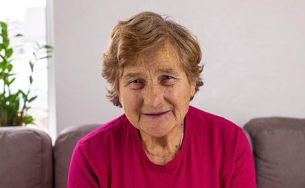 Old woman portrait at home Selective focus