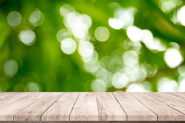 Old wood plank with abstract natural green blurred bokeh background for product display