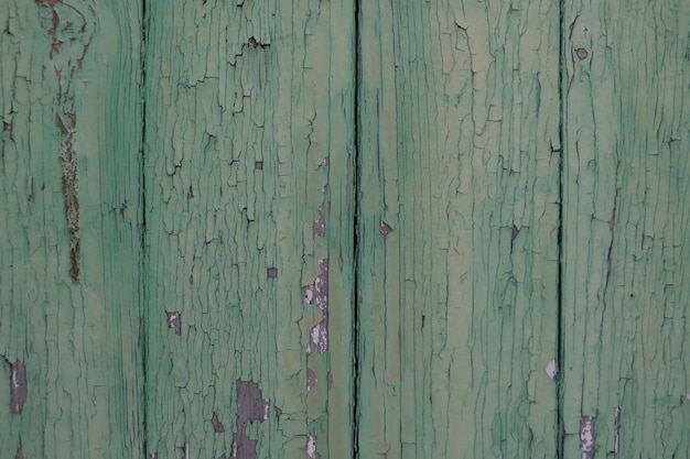 Old wood texture with peeling green paint Background