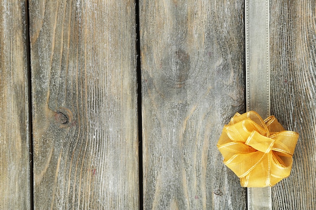 Old wooden background with beautiful bow