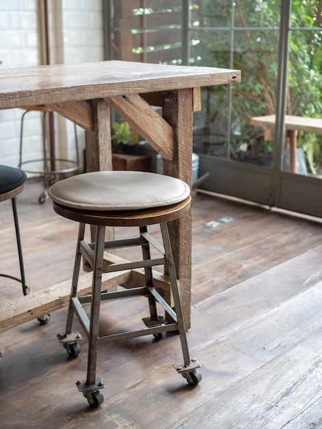 Old wooden bar stools on wooden floor in cafe retro style