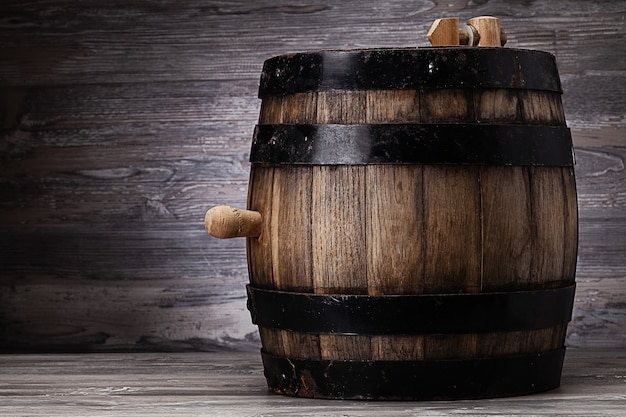 Old wooden barrel standing on table in old cellar