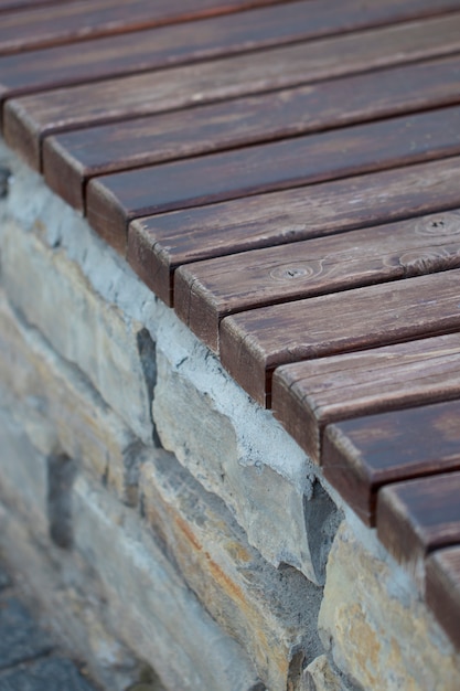 Old wooden bench in the stone wall