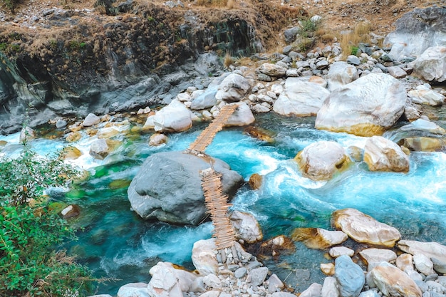 Old Wooden Bridge on a beautiful blue river in Darchula Nepal during Trekking Himalayas