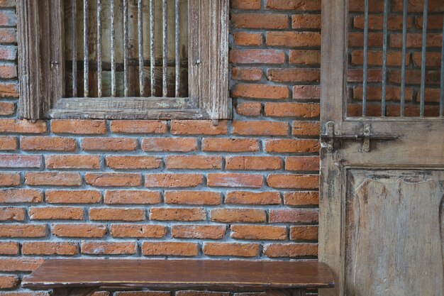 Old wooden door window & brick wall