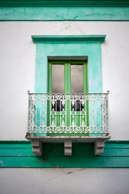 Old wooden entrance door on facade of antique baroque building in traditional architecture of Catania Sicily, Italy.