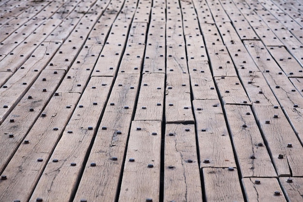 Old wooden flooring made of planks and rusty rivets