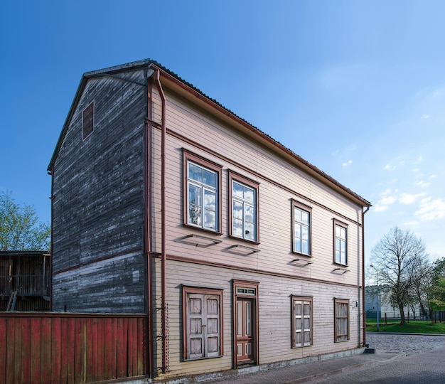 Old wooden house and a fence in Ventspils. It is a city in the Courland region of Latvia. Latvia is one of the Baltic countries