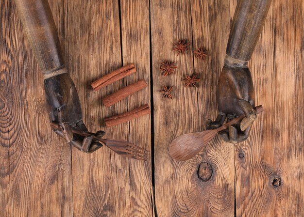 old wooden mannequin hands on wooden background