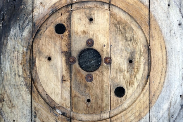 Old wooden rool with round hole for a fiber cable reel