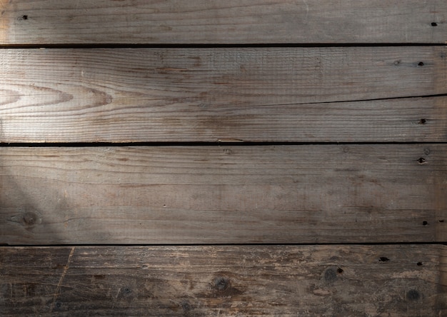 Old wooden surface with a ray of light background