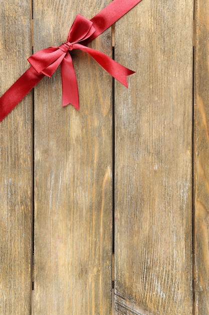 Old wooden table background with beautiful bow