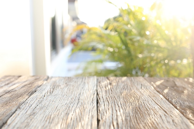 Old wooden table surface and nature view with sunlight