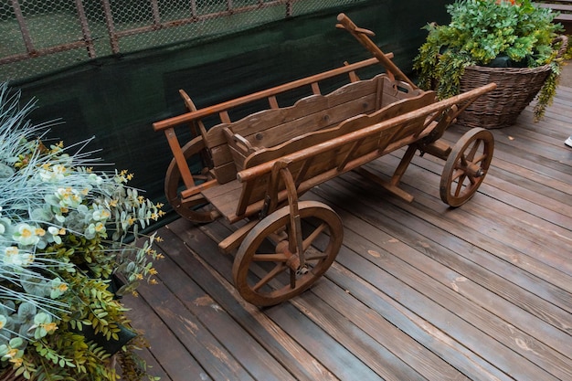 An old wooden trailer stands outdoors on the floor Vehicle Country Equipment Historic Historical Outdoors Village American Arizona Farming Nostalgia Outside Pull