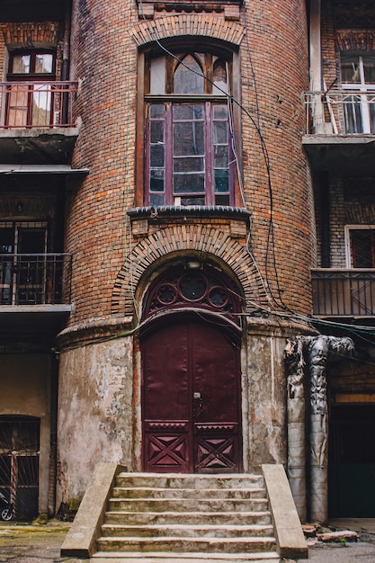 Old wooden weathered door in ancient town architecture.