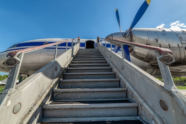 Photo old, worn passenger gangway. gangway attached to the aircraft.