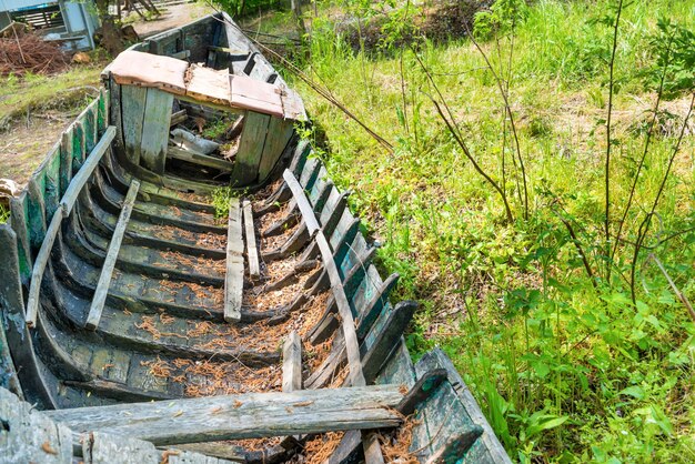 Old wrecked fishing boat on the river bank