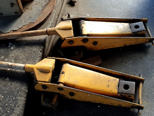 Old yellow hydraulic floor jacks in the garage