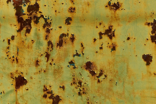 Old yellow painted wall with rust texture. Grunge rusted metal background. Rust stains