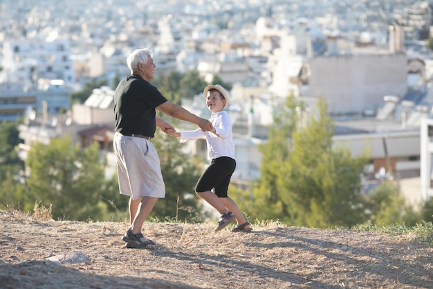 Old and Young Family generation and relations concept Retired grandfather and grandson playing with on sunny day enjoying outdoor