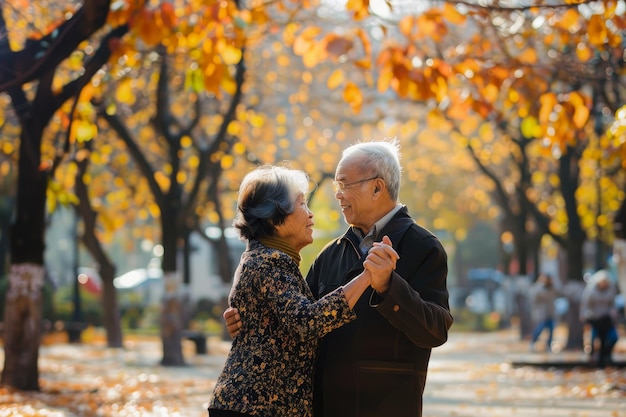 An older couple dancing together in a park during autumn surrounded by colorful foliage An older couple dancing together in a picturesque park