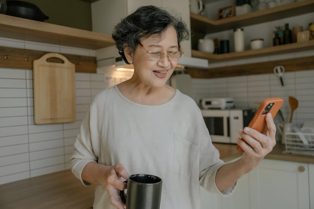 an older woman holding a cup of coffee and a mug of coffee