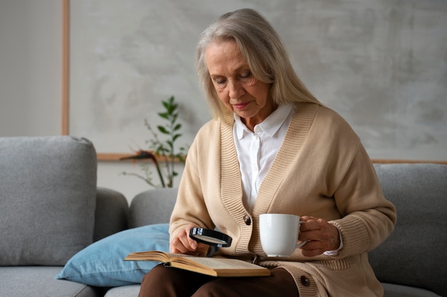 Older woman using a magnifying glass to read