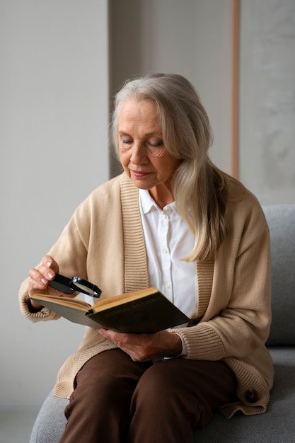 Older woman using a magnifying glass to read