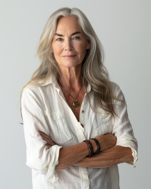 An older woman with long white hair and a white shirt