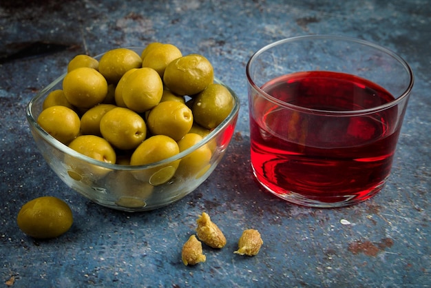 Olive appetizer with a glass of wine.