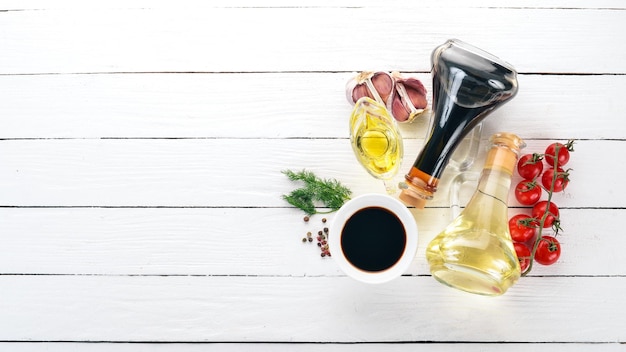 Olive oil and soy sauce in glass jars Spices and Sauce Top view On a white wooden background Free space for text