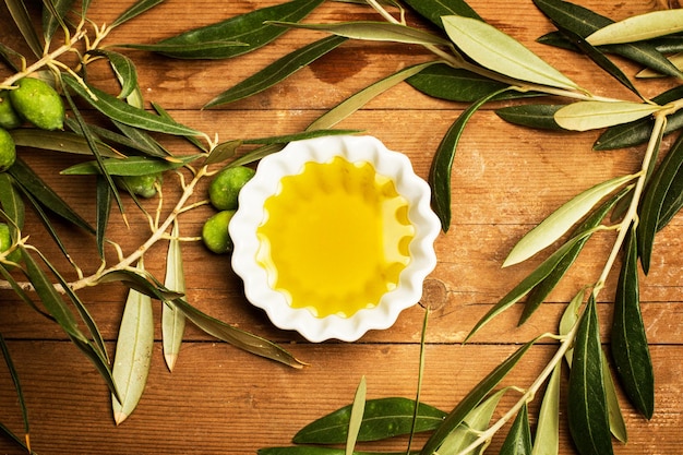 Olive oil in a white bowl on a wooden table