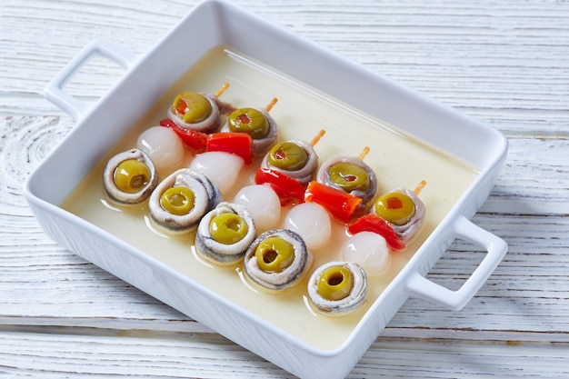 Olives anchovies and pickled onion pinchos