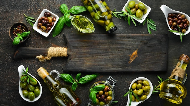 Olives olive oil spices and herbs on the Rustic background Top view Free space for your text