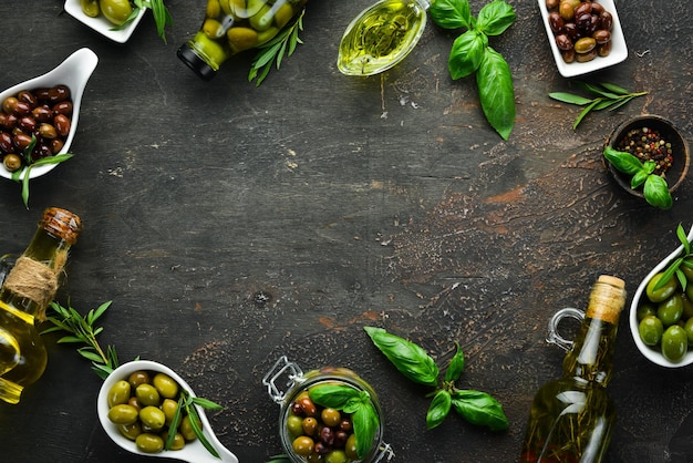 Olives olive oil spices and herbs on the Rustic background Top view Free space for your text