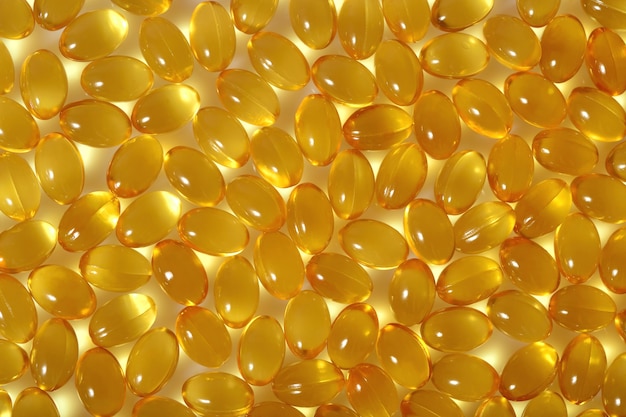 Omega-3 fish fat oil capsules as background texture