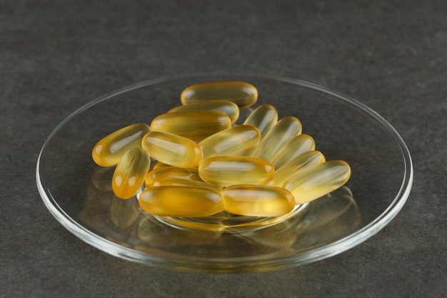 Omega 3 gelatin capsules closeup on a glass plate