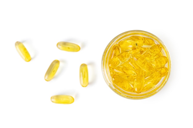 Omega 3 yellow capsules in glass bottle isolated on white background