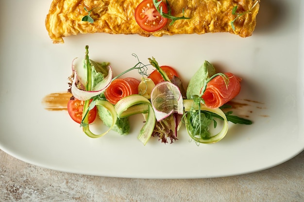 Omelet with avocado mousse and salmon in a plate Selective Focus Noise in postproduction