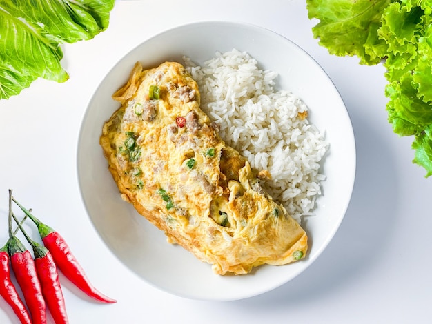 Omelet with pork and chili on rice on the white background