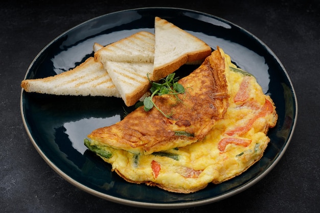 Photo omelet with vegetables and toast on a plate breakfast