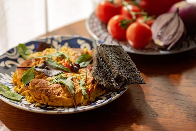 Omelette scramble ostrich egg shakshuka with vegetables and salad and homemade bread Farm organic food Cooking food Soft selective focus