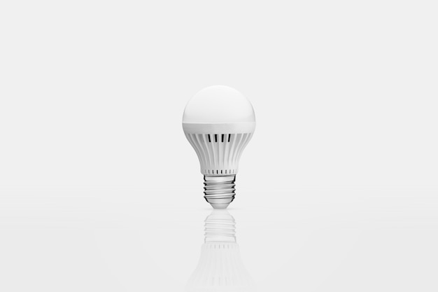 One energy saving lamp on a white background with reflection