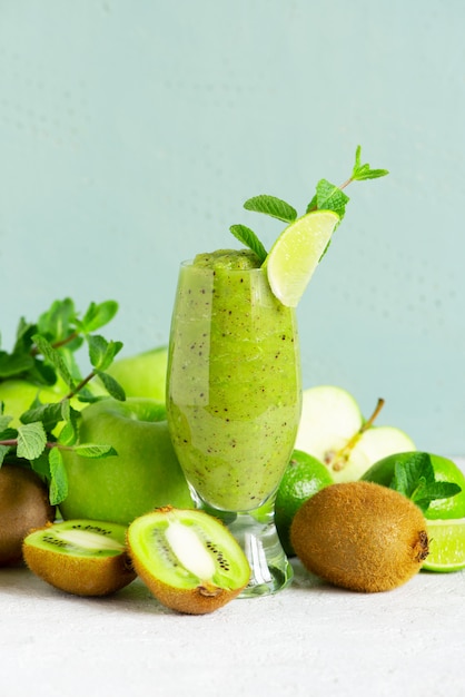  One glass of fresh green fruit smoothie on the table