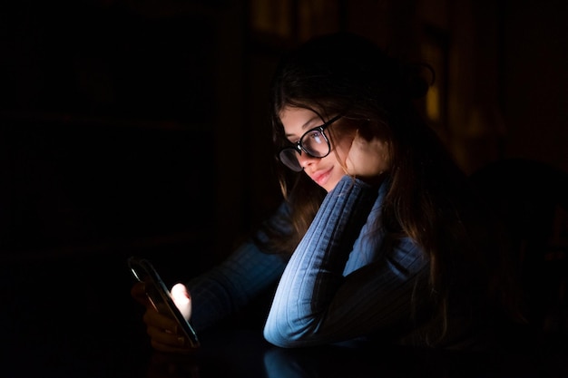 One happy and imnsoniac your woman using phone late at night in the bedroom at home chatting Online girl surfing the net revising social media Technology concept using internet