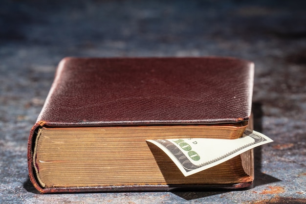 One hundred dollar bookmark note in an old book.