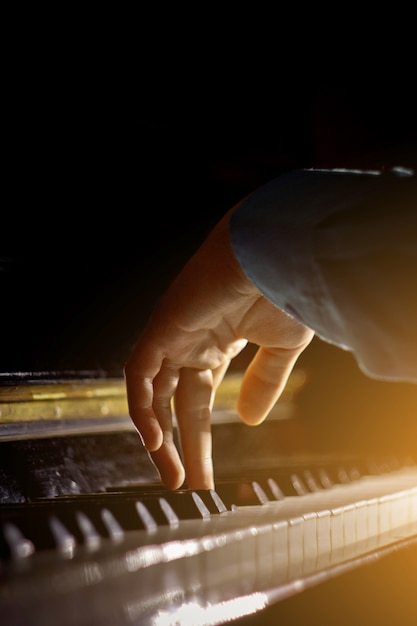 One male hand on the piano. 