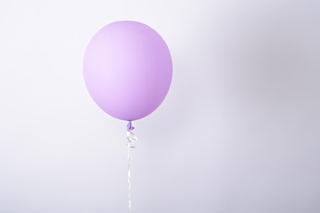 One minimal purple balloon on white background copy space element of decorations for birthday party wedding festival